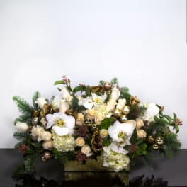 White orchids and cream roses arranged in a gold box with ornaments