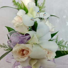 Bouquet of white orchids and pale roses with purple ribbon