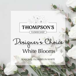 White floral shop sign with eucalyptus and white blooms
