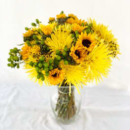 Yellow mixed bouquet in a clear glass vase