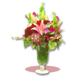 Mixed bouquet of lilies, roses, and chrysanthemums in a glass vase