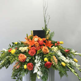 Large orange and yellow floral spray with roses and lilies