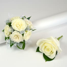Small ivory rose wedding bouquet with matching single rose boutonniere on a white background