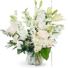 White floral arrangement with lilies and roses in a glass vase