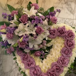 Heart-shaped floral arrangement with lavender roses and white lilies