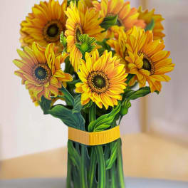 Bouquet of yellow-orange sunflowers in a green wrapped vase