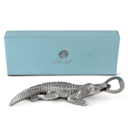 Silver alligator-shaped bottle opener with a light blue box