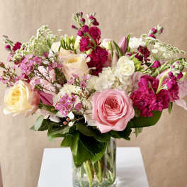 Pink and white mixed flower bouquet in a clear glass vase