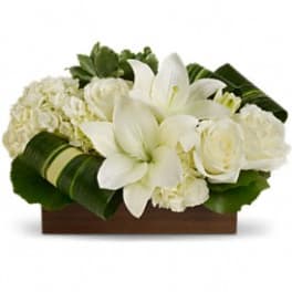 White floral arrangement in a rectangular wooden container