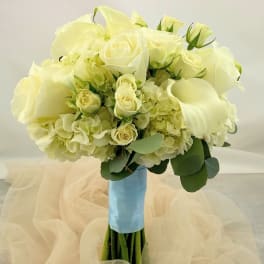 White rose and hydrangea bouquet with calla lilies and blue ribbon wrap