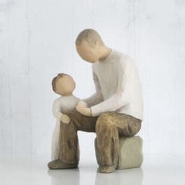 Wooden figurine of an adult and child sitting together