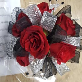 Bouquet of red roses with black and silver ribbon accents