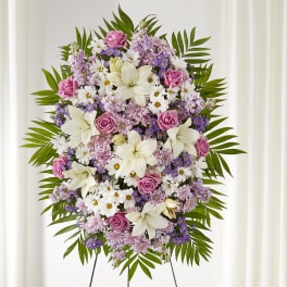 Standing floral spray with pink roses, white lilies, and purple daisies