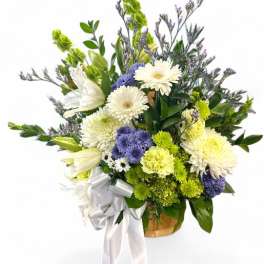 Bouquet of white, purple, and green flowers with a white ribbon