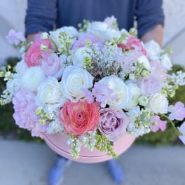 Pink and white mixed bouquet in a round pink box