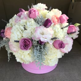 Pink and white bouquet in a round pink box