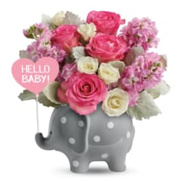 Pink and white roses in a gray elephant vase with a "Hello Baby!" sign