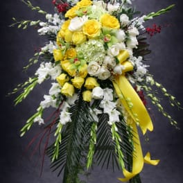 Standing floral spray with yellow and white roses and white orchids