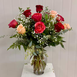 Bouquet of red and peach roses in a clear glass vase