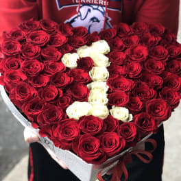 Heart-shaped bouquet of red and white roses in a gift box