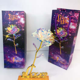 Decorative crystal rose on a gold base with two gift bags