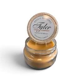 Jar candle with a round lid labeled Tyler Candle Company