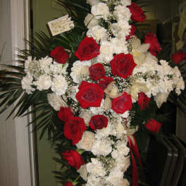 Cross-shaped floral spray with red roses and white carnations
