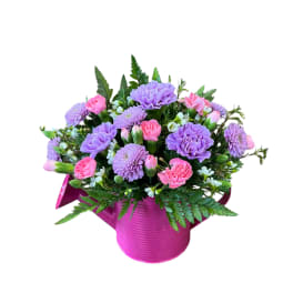 Pink and lavender mixed bouquet in a magenta container