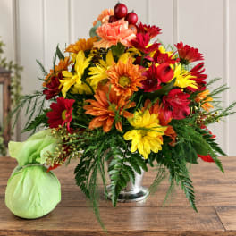Bright mixed bouquet in a silver vase with a green wrapped accent