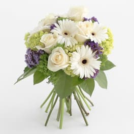 Bouquet of white roses and gerbera daisies with purple accents