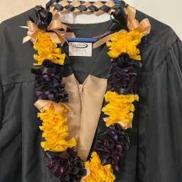 Black and yellow lei with black and gold ribbon