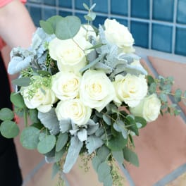 Bouquet of white roses with eucalyptus and silvery foliage