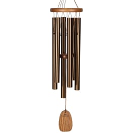 Bronze wind chime with wooden accents hanging on a white background