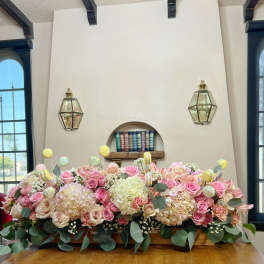 Large pastel floral arrangement with pink and cream roses and hydrangeas