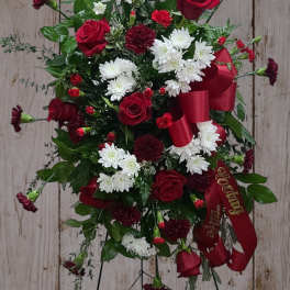 Standing floral spray with red roses, white chrysanthemums, and burgundy carnations