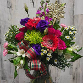 Colorful mixed bouquet in a glass vase with a plaid ribbon