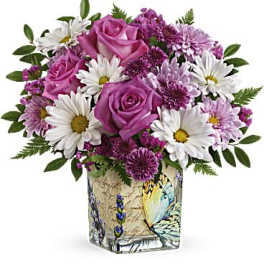 Pink roses and white daisies in a decorative square vase