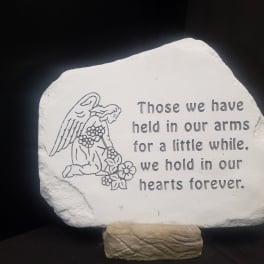 Memorial stone with an angel and remembrance quote