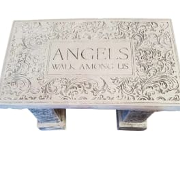 Decorative wooden bench with the words "ANGELS WALK AMONG US"