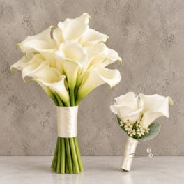 White calla lily bridal bouquet and matching boutonniere on a neutral background