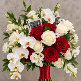 Wedding bouquet of red and white roses with white orchids and dice accents