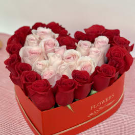 Heart-shaped box of red and pale pink roses