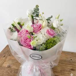 Bouquet of pink and white roses with calla lilies and eucalyptus