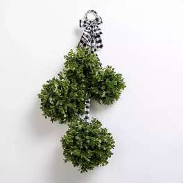 Three green topiary balls tied with a black-and-white check ribbon