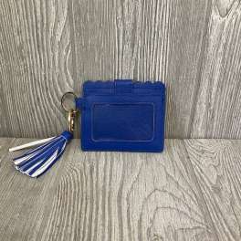 Blue card holder with a tassel keychain on a wood floor