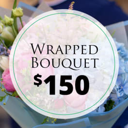 Wrapped bouquet with pink, white, and blue flowers
