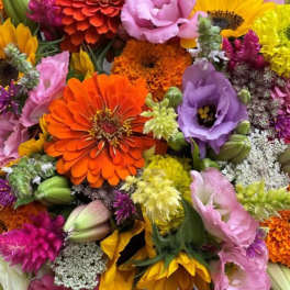 Bright mixed bouquet with orange, pink, purple, and yellow flowers