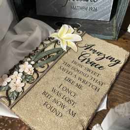 Decorative plaque with white flowers and a Bible verse