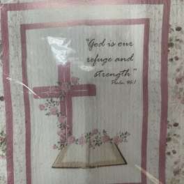Quilt with a pink cross and Bible verse text