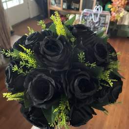 Bouquet of black roses with bright green filler
